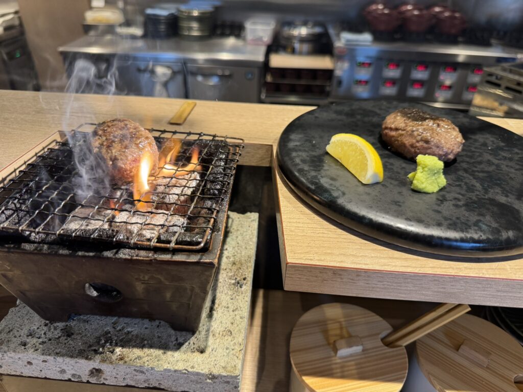 『炭焼食堂 JYUJYUTEI』ハンバーグを七輪で焼いている写真。